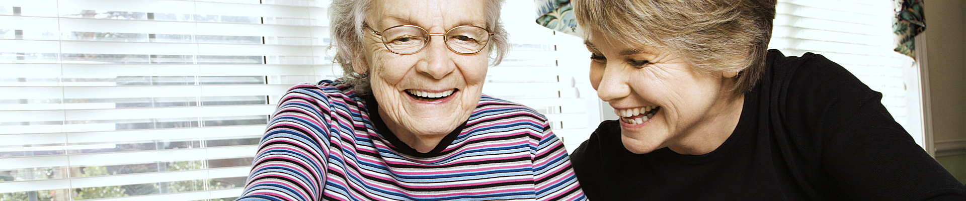 caregiver and patient laughing at something